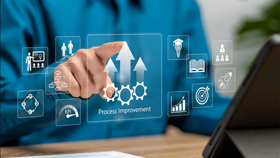 Person interacting with digital interface showing business process improvement icons like gears, KPIs, charts, and goals in a business setting