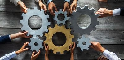 Business hands holding engineering mechanism