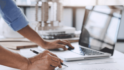 Document for engineering process with hand a laptop